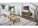 Inviting living room with hardwood floors, patterned rug, and modern decor; open to kitchen and dining area at 12309 Gambrell Dr, Charlotte, NC 28278