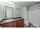 Bathroom features dark wood cabinets, a tub and a shower at 12724 Frank Wiley Ln, Charlotte, NC 28278