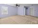 Lavender bedroom with ceiling fan, carpet, and window at 12724 Frank Wiley Ln, Charlotte, NC 28278