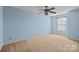 Bedroom features a ceiling fan and a window at 12724 Frank Wiley Ln, Charlotte, NC 28278
