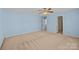 Spacious bedroom with light blue walls, neutral carpet and ceiling fan at 12724 Frank Wiley Ln, Charlotte, NC 28278