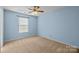Bedroom features a ceiling fan and a window at 12724 Frank Wiley Ln, Charlotte, NC 28278