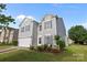 Charming two-story home with gray siding, manicured lawn, and attached two-car garage at 12724 Frank Wiley Ln, Charlotte, NC 28278