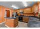Well-lit kitchen with stainless steel appliances, island, and wood cabinets at 12724 Frank Wiley Ln, Charlotte, NC 28278