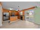 Bright kitchen with stainless steel appliances, island, and sliding glass door to backyard at 12724 Frank Wiley Ln, Charlotte, NC 28278