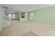 Open living room with neutral carpet, bright green walls, and plenty of natural light at 12724 Frank Wiley Ln, Charlotte, NC 28278