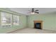 Bright living room with neutral carpet, a fireplace, and plenty of natural light at 12724 Frank Wiley Ln, Charlotte, NC 28278