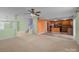 Bright living room open to kitchen, featuring staircase and neutral carpet at 12724 Frank Wiley Ln, Charlotte, NC 28278