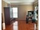 Spacious room with hardwood floors, a window offering natural light, and ample space for furnishings at 13123 Ashley Meadow Dr, Charlotte, NC 28213