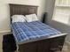 This bedroom features carpet, a bed with a blue plaid comforter, and natural light from the window at 13123 Ashley Meadow Dr, Charlotte, NC 28213