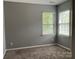 This bedroom features carpet and natural light from the two windows with blinds at 13123 Ashley Meadow Dr, Charlotte, NC 28213