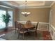 Elegant dining room featuring a chandelier, hardwood floors, and a bay window for natural light at 13123 Ashley Meadow Dr, Charlotte, NC 28213
