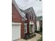 Traditional two-story brick home with black shutters and manicured landscaping at 13123 Ashley Meadow Dr, Charlotte, NC 28213