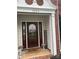 Charming front porch with a decorative glass door, sidelights, and sidelite windows at 13123 Ashley Meadow Dr, Charlotte, NC 28213