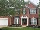 Charming two-story brick home with a manicured front yard, black shutters, and inviting entrance at 13123 Ashley Meadow Dr, Charlotte, NC 28213