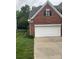 Brick home featuring a two-car garage and well maintained lawn at 13123 Ashley Meadow Dr, Charlotte, NC 28213