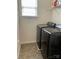 This laundry room features tile flooring, washer and dryer, and shelving for storage at 13123 Ashley Meadow Dr, Charlotte, NC 28213