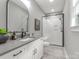 Modern bathroom featuring white cabinets, gray countertop, and glass-enclosed shower at 1445 Cherry Laurel Dr, Waxhaw, NC 28173