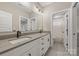 Modern bathroom features double sinks, gray quartz counters, and white cabinets at 1445 Cherry Laurel Dr, Waxhaw, NC 28173