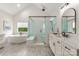 Bright and airy bathroom with freestanding tub, glass shower, and double vanity sinks at 1445 Cherry Laurel Dr, Waxhaw, NC 28173