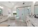 Bright bathroom featuring a walk-in shower, soaking tub, and double vanity with white cabinets and neutral countertops at 1445 Cherry Laurel Dr, Waxhaw, NC 28173
