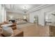 Spacious primary bedroom featuring a seating area, tray ceilings, and hardwood floors at 1445 Cherry Laurel Dr, Waxhaw, NC 28173