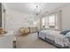 Charming bedroom with neutral walls, a plush chair, a chandelier, and a soft carpeted floor at 1445 Cherry Laurel Dr, Waxhaw, NC 28173