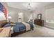Bedroom showcases an accent wall, hardwood furnishings, natural light, and an adjoining bathroom at 1445 Cherry Laurel Dr, Waxhaw, NC 28173