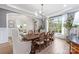 Elegant dining room with modern chandelier, hardwood floors, and open access to living space at 1445 Cherry Laurel Dr, Waxhaw, NC 28173