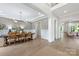 The dining room features hardwood floors, a modern chandelier, and neutral decor with an open plan at 1445 Cherry Laurel Dr, Waxhaw, NC 28173