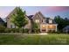 Charming brick home featuring a manicured lawn, elegant entrance, and inviting front porch at 1445 Cherry Laurel Dr, Waxhaw, NC 28173