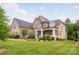 Charming brick home features a landscaped front yard and covered front porch at 1445 Cherry Laurel Dr, Waxhaw, NC 28173