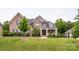 Well-maintained brick home with a lush green lawn and manicured landscaping at 1445 Cherry Laurel Dr, Waxhaw, NC 28173