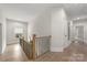 Hallway with hardwood floors, a wooden staircase, and white walls with modern trim accents at 1445 Cherry Laurel Dr, Waxhaw, NC 28173