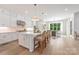 Bright, white kitchen with stainless steel appliances, large island, and hardwood floors at 1445 Cherry Laurel Dr, Waxhaw, NC 28173