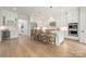 The bright kitchen features an island with seating, stainless appliances, and hardwood floors at 1445 Cherry Laurel Dr, Waxhaw, NC 28173