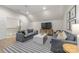 Bright living room featuring neutral walls, wood floors, and a comfortable seating arrangement at 1445 Cherry Laurel Dr, Waxhaw, NC 28173