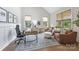 Comfortable home office space with hardwood floors, modern decor, and natural light from multiple windows at 1445 Cherry Laurel Dr, Waxhaw, NC 28173