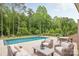 Backyard pool with a patio area featuring ample seating and shade at 1445 Cherry Laurel Dr, Waxhaw, NC 28173