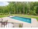 Backyard pool features a stone patio with lounge chairs at 1445 Cherry Laurel Dr, Waxhaw, NC 28173