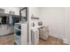 Walk-in closet featuring custom shelving, a vanity with a chair and storage drawers at 1445 Cherry Laurel Dr, Waxhaw, NC 28173