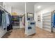 Organized walk-in closet with custom shelving and ample storage for clothing and shoes at 1445 Cherry Laurel Dr, Waxhaw, NC 28173