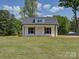 Charming home with vertical siding, black shutters, and inviting front porch at 1454 King Rd, York, SC 29745