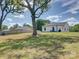 An exterior view of the modern farmhouse showcasing its clean lines and rural surroundings at 1454 King Rd, York, SC 29745