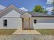 Side exterior of new construction white home with black roof and gravel driveway at 1454 King Rd, York, SC 29745