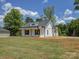 Side view of a white home with a covered front porch and manicured lawn at 1454 King Rd, York, SC 29745