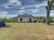 White house with black trim surrounded by lush greenery and clear blue skies, beautiful countryside living at 1454 King Rd, York, SC 29745