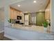 Open kitchen with stainless steel appliances, granite counters, and light wood cabinets at 1454 King Rd, York, SC 29745