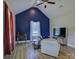 Vaulted ceiling, neutral furniture and blue accent wall make a modern living space at 1454 King Rd, York, SC 29745