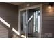A cozy outdoor balcony with sliding glass door access and a 'Welcome to Paradise' sign above at 14621 Waterside Dr, Charlotte, NC 28278